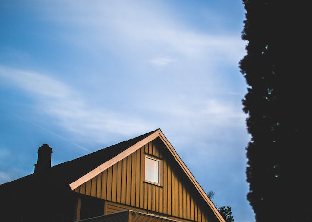 Roof of a house against a blue sky at dusk